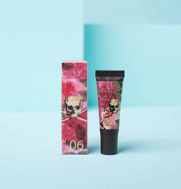 Tube and box of decorative Dead Sexy Lip Tint feature pink florals, green leaves, and skull and crossbones illustrations