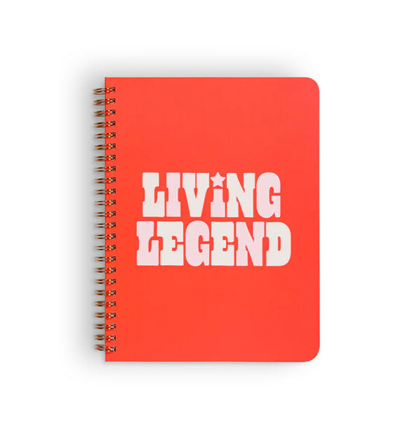 Red spiral-bound notebook cover says, "Living Legend" with star accent above the I