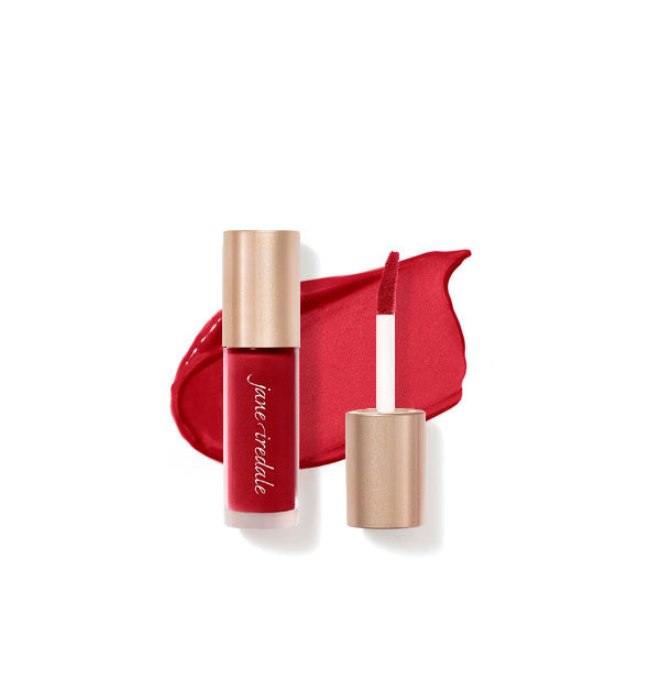 Tube of Jane Iredale Beyond Matte Lip Stain with separate gold doe foot applicator cap rest atop an enlarged sample application of product in shade Longing