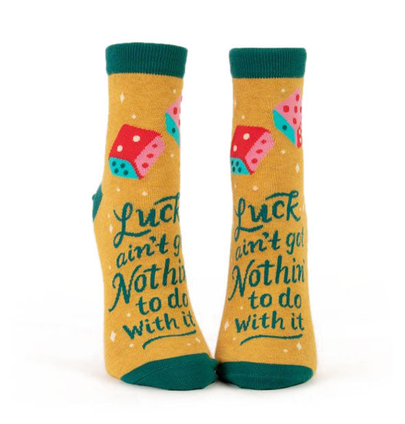 Mustard yellow crew socks with dark teal bands, toes, and heels say, "Luck ain't got nothin' to do with it" across the front with colorful dice graphics