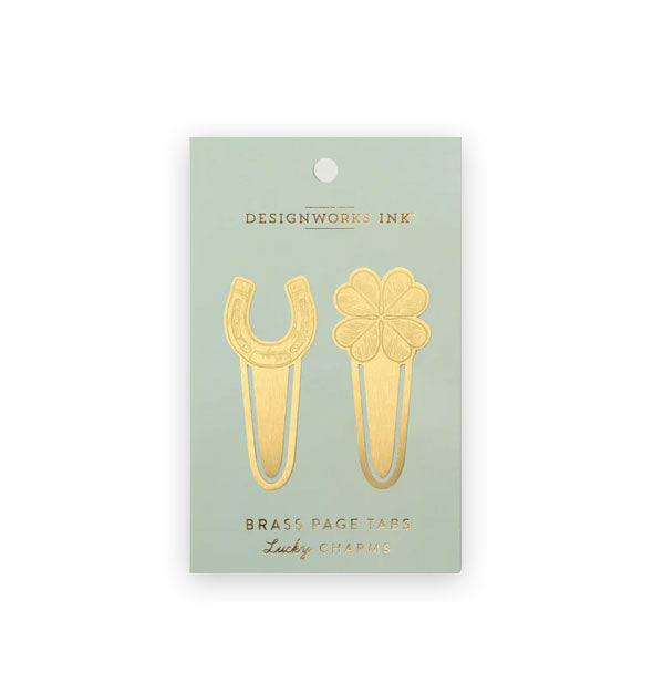Gold-toned horseshoe and four-leaf clover brass page tabs on a pastel mint DesignWorks Ink product card