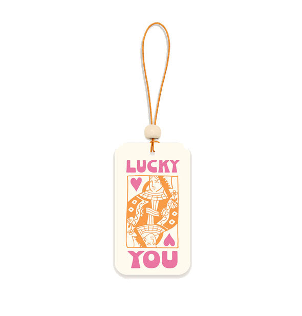 Rectangular white air freshener card on orange string with white bead accent says, "Lucky you" in pink around an orange and pink queen of hearts playing card design