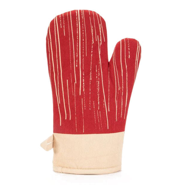 Red and white oven mitt with irregular white lines in the red space