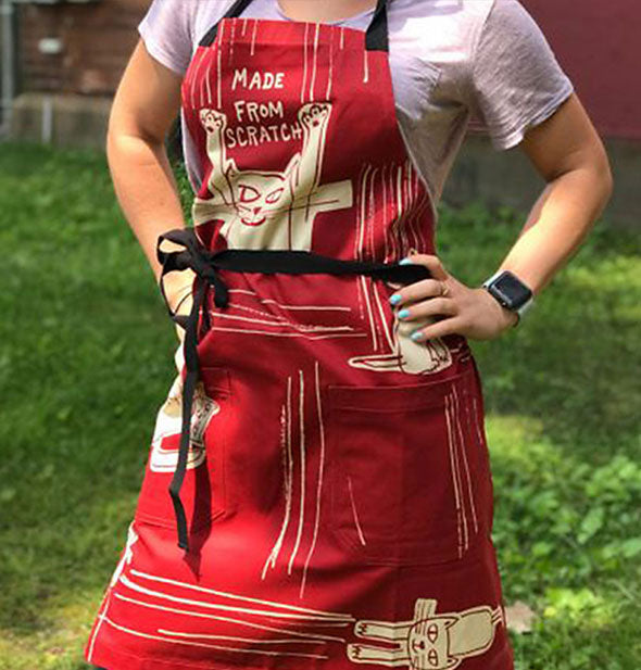 A model wears the Made From Scratch cat apron