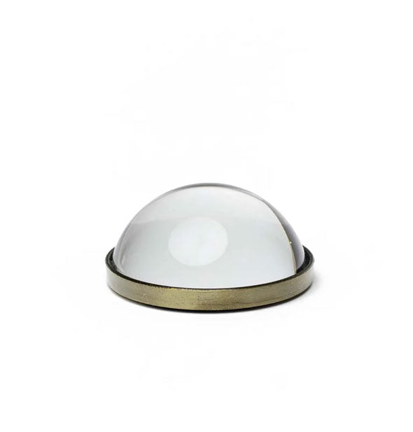 Round domed glass magnifier with a brassy rim around the bottom