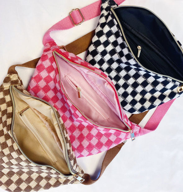Three opened checkered knit sling bags in black and white, light pink and dark pink, and brown and cream show interior zippered pockets