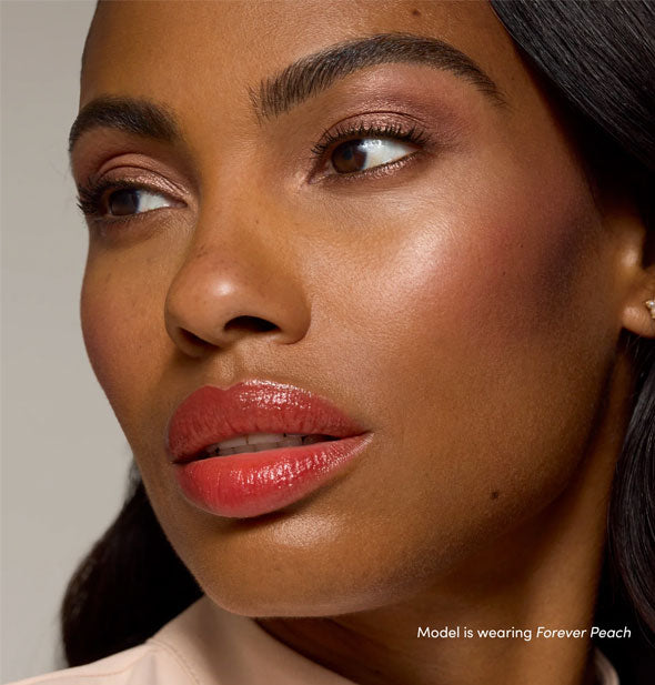 Model wearing Forever Peach shade of Jane Iredale Just Kissed Lip and Cheek Stain