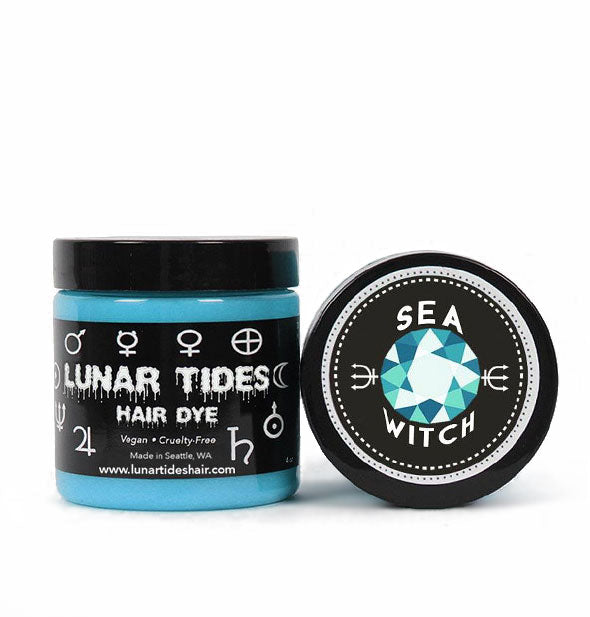 Pot of Lunar Tides Hair Dye in blue shade Sea Witch with black and white label next to product lid of the same design set on its side to show label