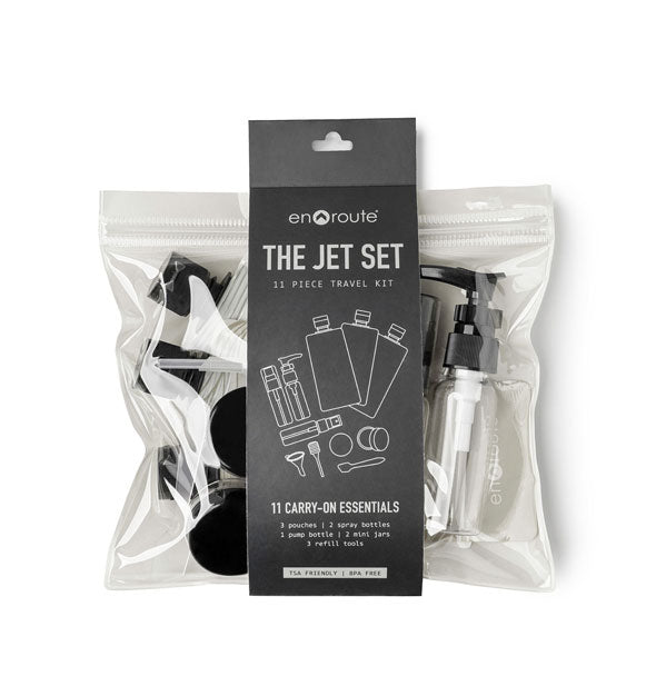 The Jet Set 11-Piece Travel Kit by En Route in clear plastic with dark gray wrap-around label