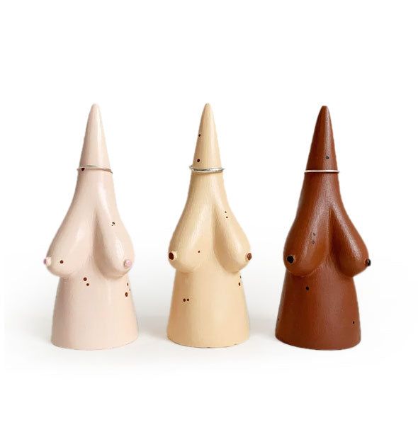 Conical ring holders with breasts in light pinkish, medium goldish, and dark brown shades