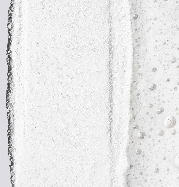 Closeup of Dermalogica Daily Microfoliant powder partially mixed with water to create a sudsy paste
