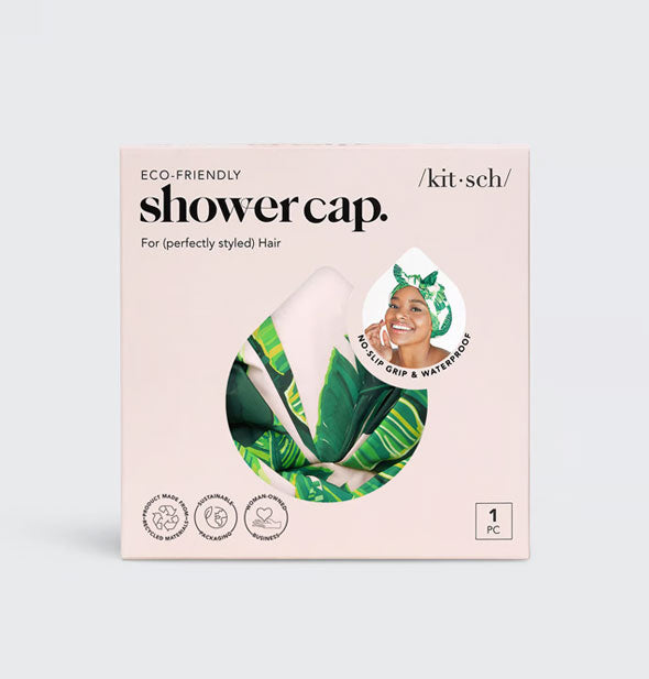 Kitsch Eco-Friendly Shower Cap packaging with palm leaf print cap partially visible through teardrop-shaped window in packaging