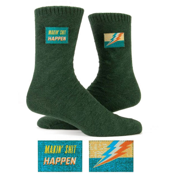 Dark green woven socks with sewn-in ankle labels, one featuring a colorful lightning bolt and the other saying, "Makin' Shit Happen"