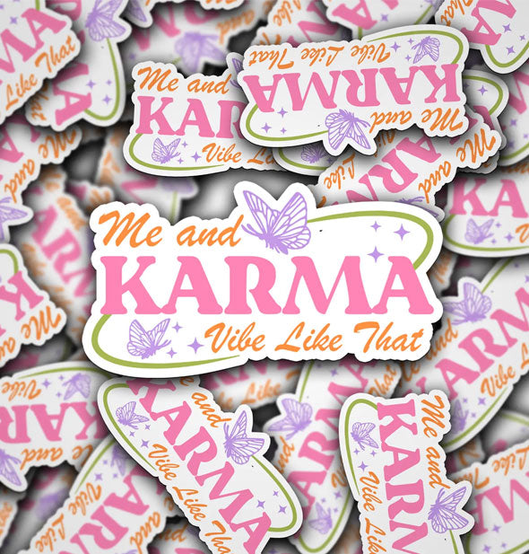 Pile of stickers that say, "Me and karma vibe like that" in orange and pink lettering accented by green swooshes, purple butterflies, and small purple stars