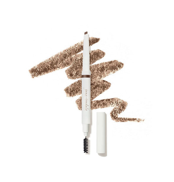 White Jane Iredale brow pencil with cap removed to show angled tip on top and spoolie brush on bottom is placed in front of a drawn squiggle of product in shade Medium Brown