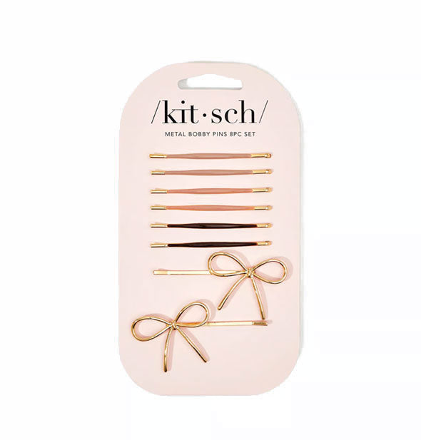 Set of eight bobby pins, six with neutral enamel covering over gold hardware and two with bow accent details, on light pink Kitsch product card