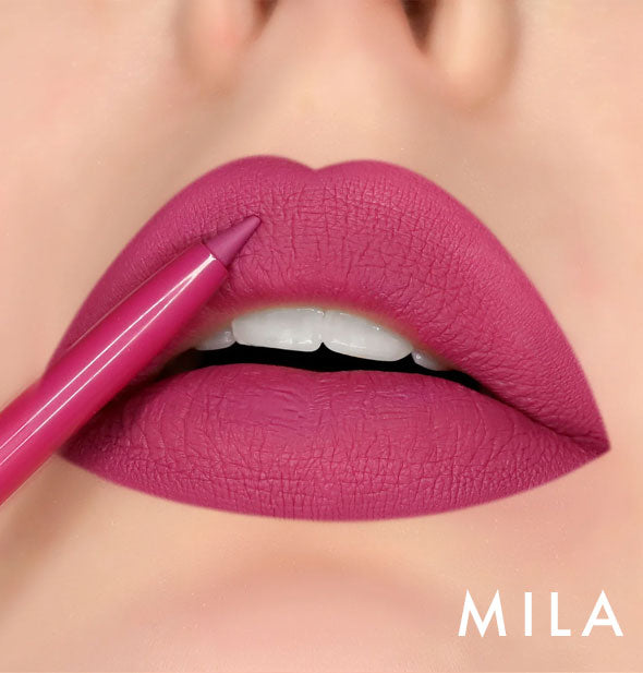 Model's lips wear shade Mila of Kara Beauty Line Up Lip Liner; pencil tip is held up to upper lip