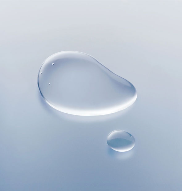 Closeup of droplets of Oribe Mirror Rinse Glass Hair Treatment