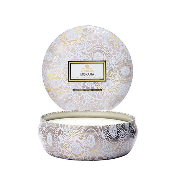 Round white floral Mokara Voluspa tin candle with lid removed