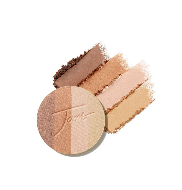 Four-shade bronzer pressed powder compact refill disc stamped with "Jane" is placed in front of crumbled and streaked applications of each shade in Moonglow option