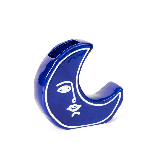 Blue ceramic crescent moon vase with painted white facial features and border