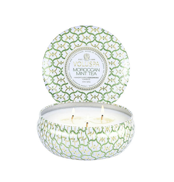 Green and white decorative Voluspa Moroccan Mint Tea candle tin with three burning wicks