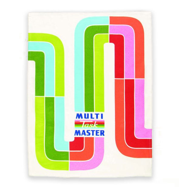 White dish towel with colorful rainbow design says, "Multi Task Master"