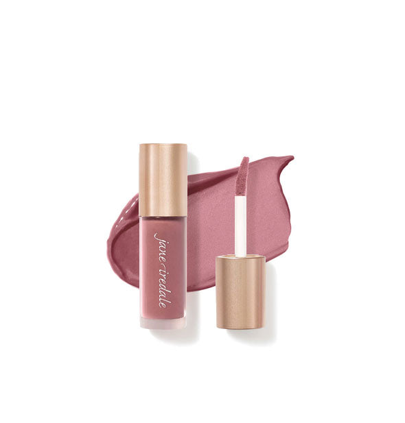 Tube of Jane Iredale Beyond Matte Lip Stain with separate gold doe foot applicator cap rest atop an enlarged sample application of product in shade Muse