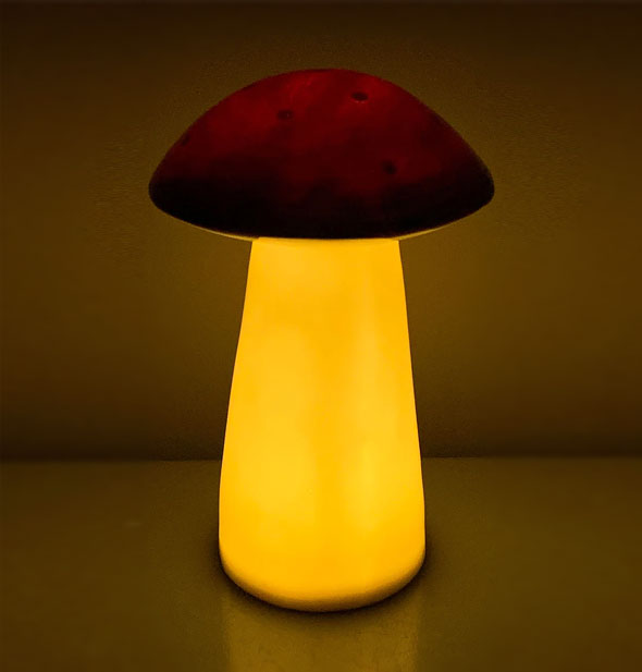 Lit-from-within mushroom lamp in a darkened space