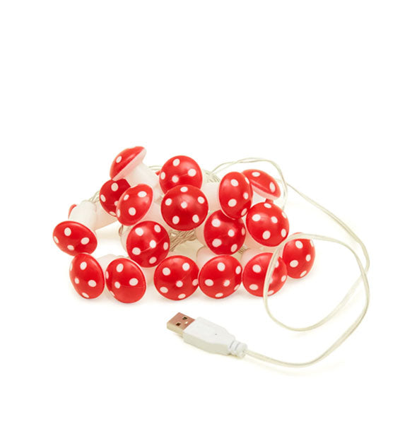 Cluster of red and white spotted mushroom lights on a white cord with USB plug at the end