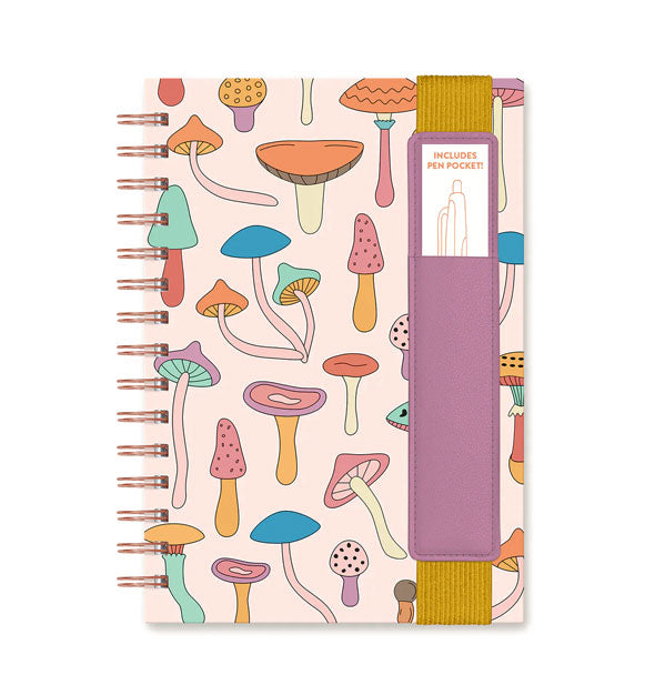 Notebook with rose gold twin ring spiral binding features colorful mushroom cover illustrations and a mustard and lavender pen sleeve