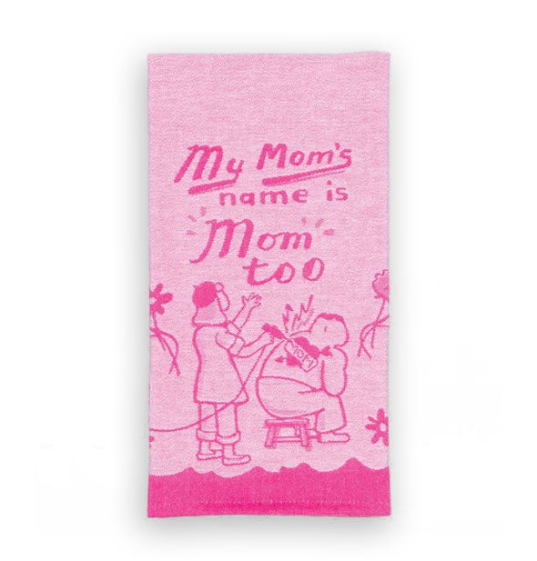 Pink dish towel says, "My mom's name is Mom too" above an illustration of a beret-wearing tattoo artist drawing a "Mom" heart tattoo on a man's back