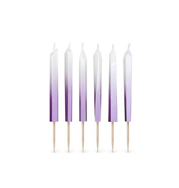 Six purple-to-white ombre crystal-shaped cake candles with toothpick ends