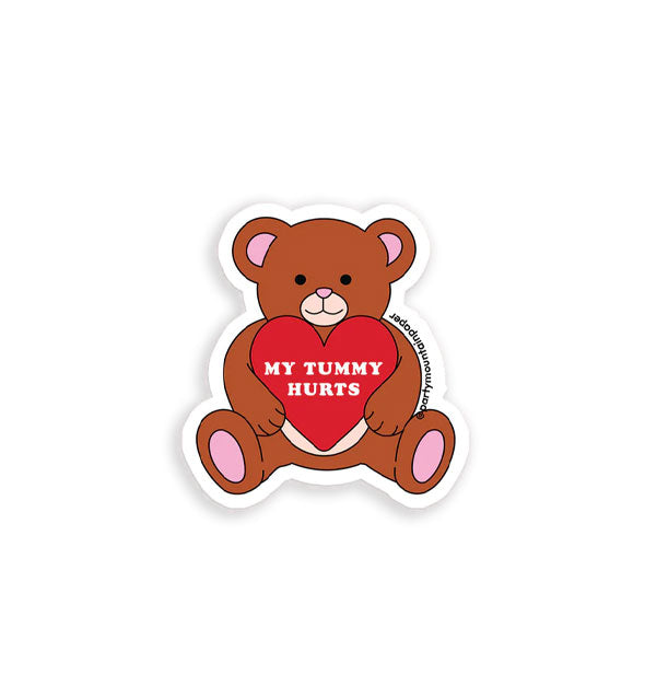 Sticker with white border features illustration of a brown teddy bear with pink details holding a red heart that says, "My tummy hurts" in white lettering