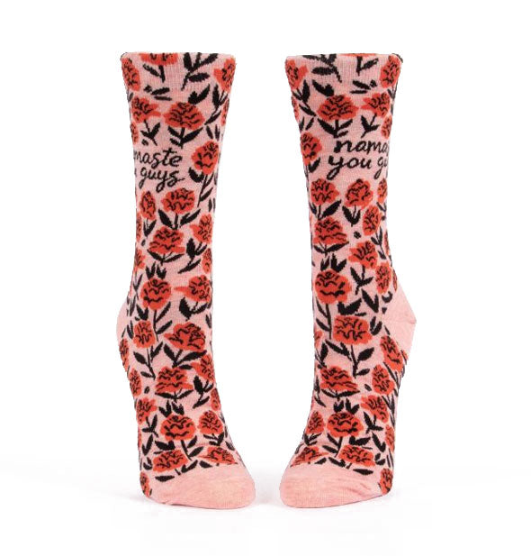 Pink crew socks with all-over floral illustrations say, "Namaste you guys"