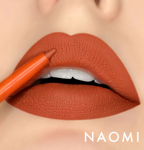 Model's lips wear shade Naomi of Kara Beauty Line Up Lip Liner; pencil tip is held up to upper lip