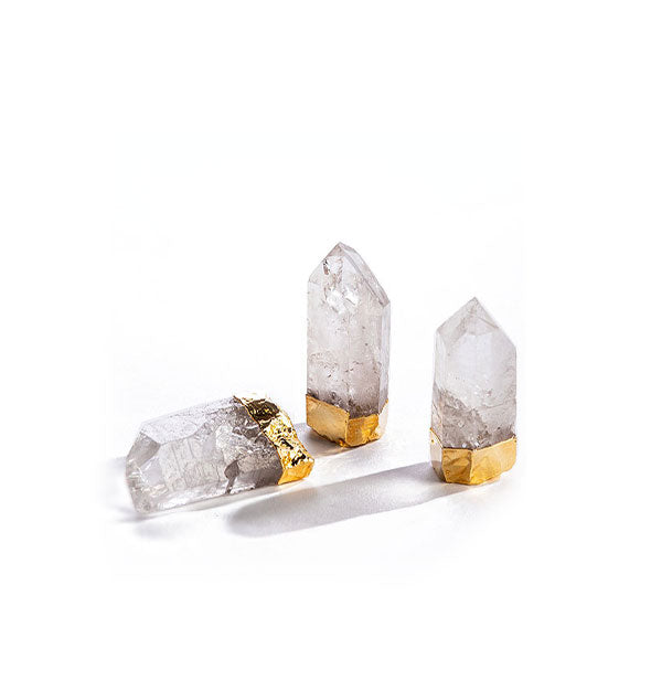 Clear crystal quartz points with gilded bases