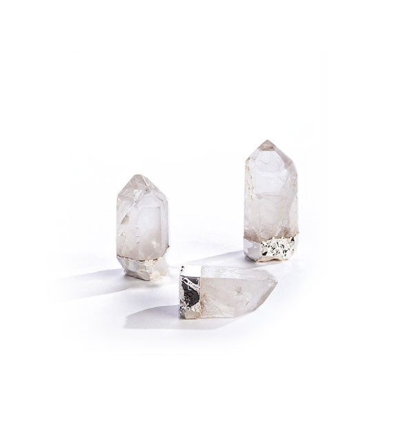 Three clear quartz points with bases gilded in silver plating