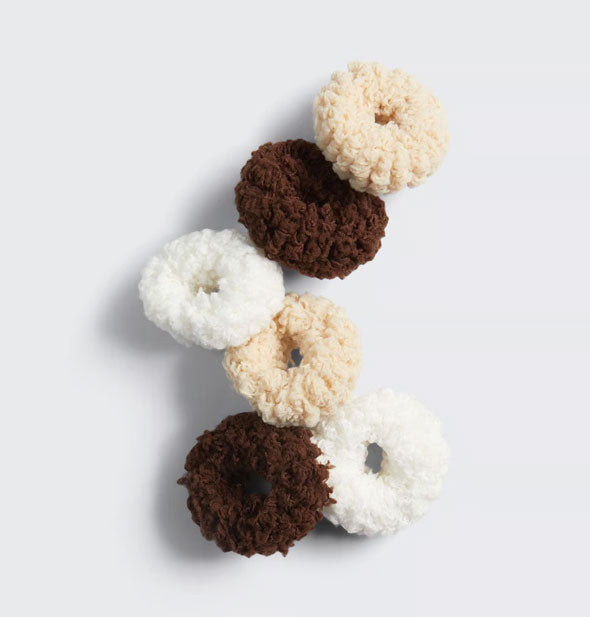 Two white, two cream, and two brown fluffy cotton hair scrunchies spread out