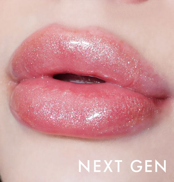Closeup of model's lips wearing Kara Beauty Level Up! Nourishing Lip Gloss in Next Gen pink with very fine gold sparkles