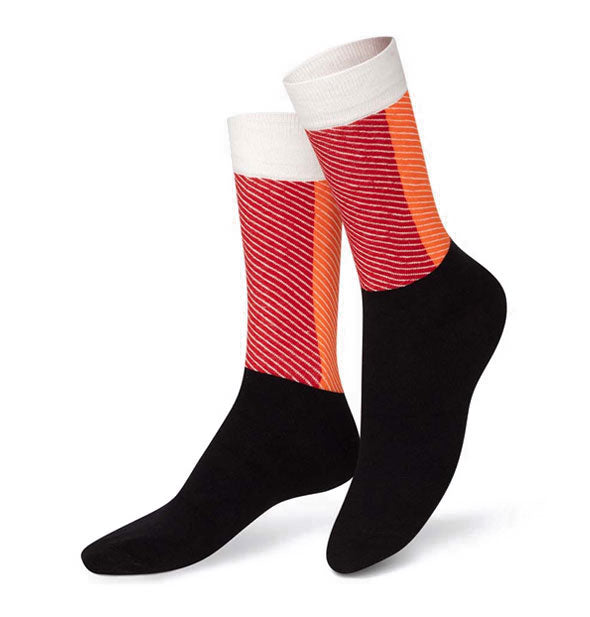 Pair of crew socks with black bottom halves and two-tone striped red and orange top halves with white borders