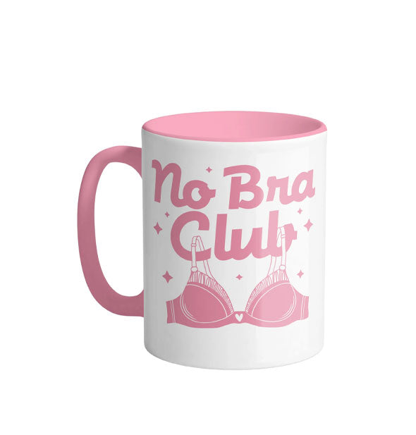 White coffee mug with pink handle and interior says, "No Bra Club" in large script lettering accented by stars with a pink brassiere graphic
