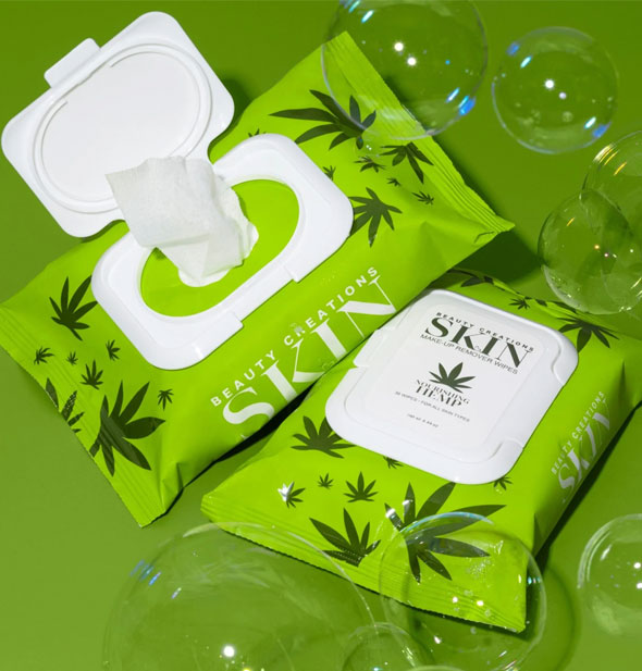 One closed and one opened pack of Nourishing Hemp Beauty Creations Skin Makeup Remover Wipes staged with bubbles on a green backdrop