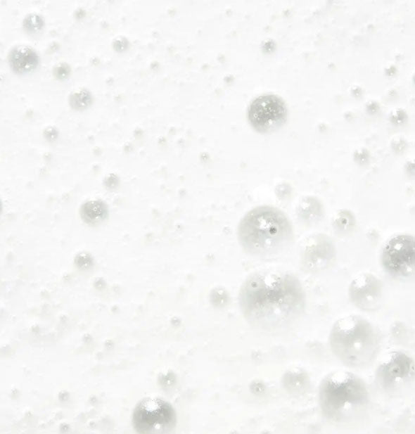 Closeup of white, bubbly shampoo