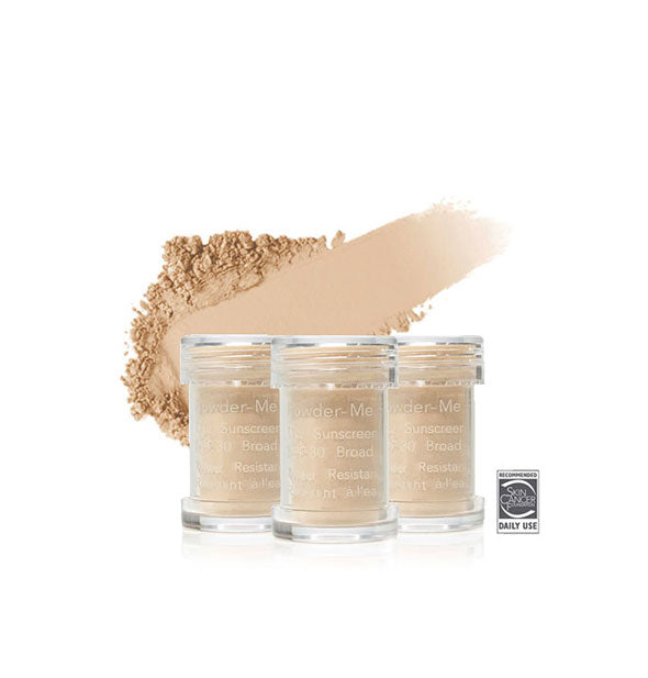 Three refill canisters of Jane Iredale Powder-Me SPF 30 Dry Sunscreen with enlarged swiped sample application behind them in shade Nude