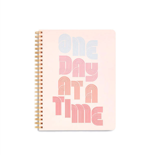 Light pink notebook cover with spiral binding says, "One day at a time" in decorative striped lettering