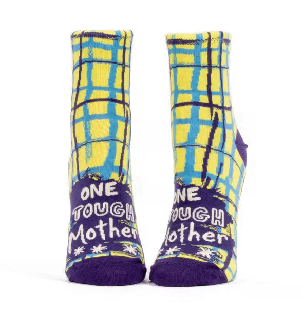 Yellow and blue socks with wobbly plaid pattern say, "One tough mother" in white lettering