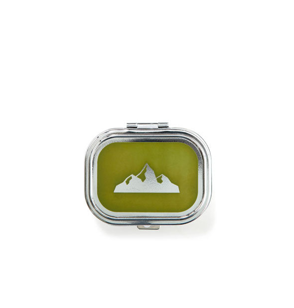 Rectangular silver box lid with rounded corners and green center with silver mountain emblem