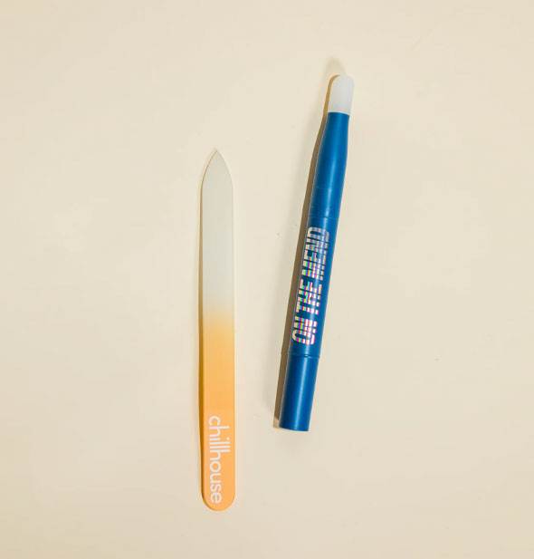 Contents of the On the Mend kit: blue dual-ended cuticle pushover and orange ombre file