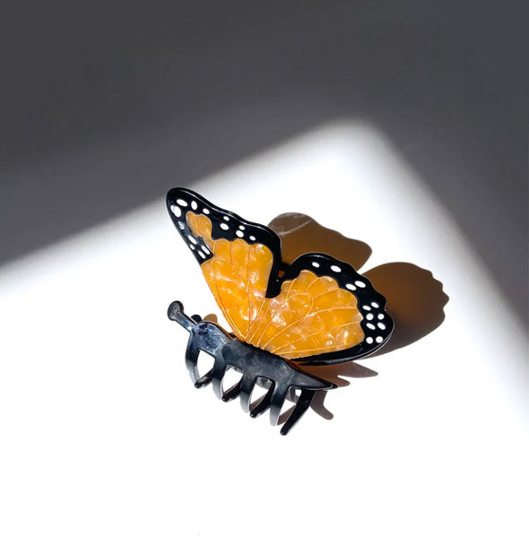 Orange, black, and white monarch butterfly claw clip with gold line details